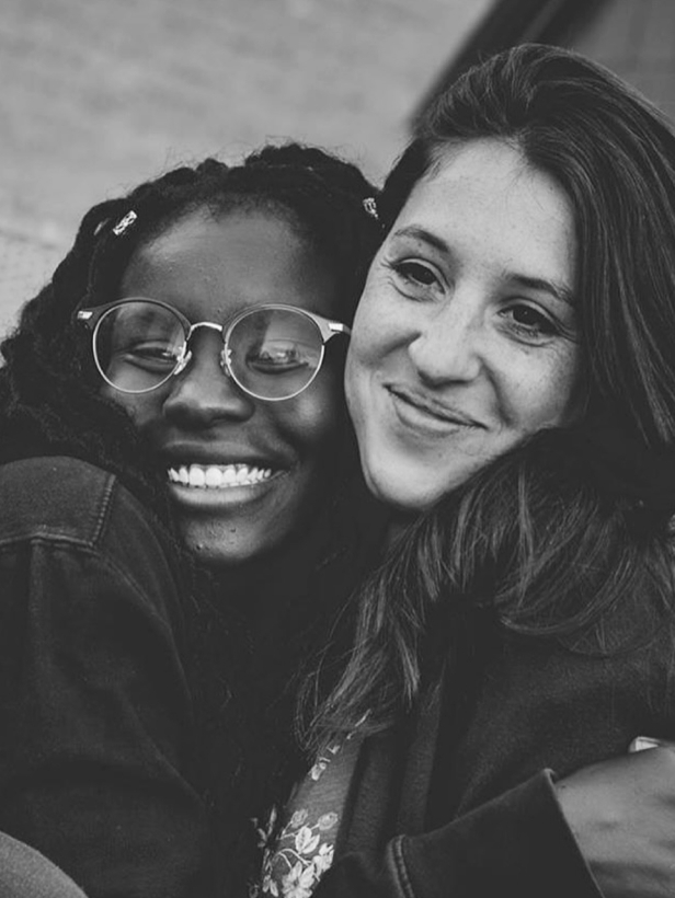 Two young women hugging in monochrome photo